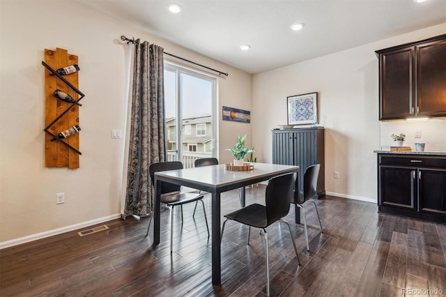 dining space with dark hardwood / wood-style flooring