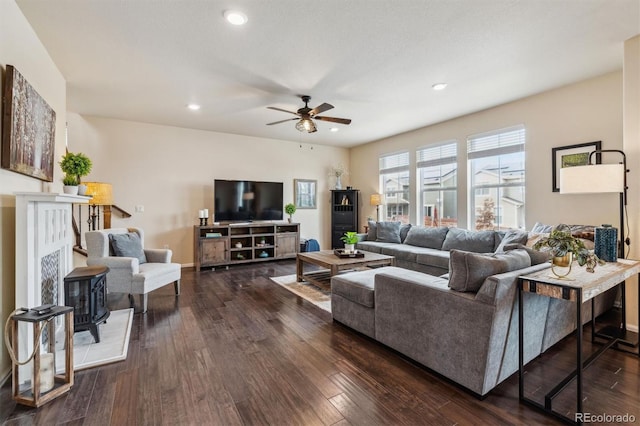 living room with ceiling fan and dark hardwood / wood-style floors