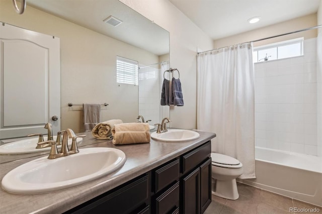 full bathroom with shower / tub combo with curtain, vanity, toilet, and tile patterned flooring