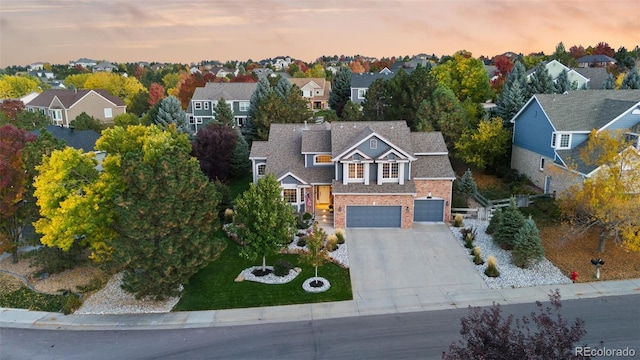 aerial view at dusk featuring a residential view