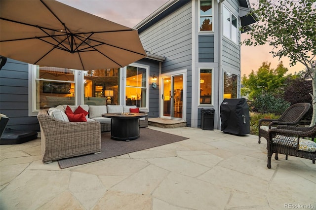 patio terrace at dusk featuring grilling area