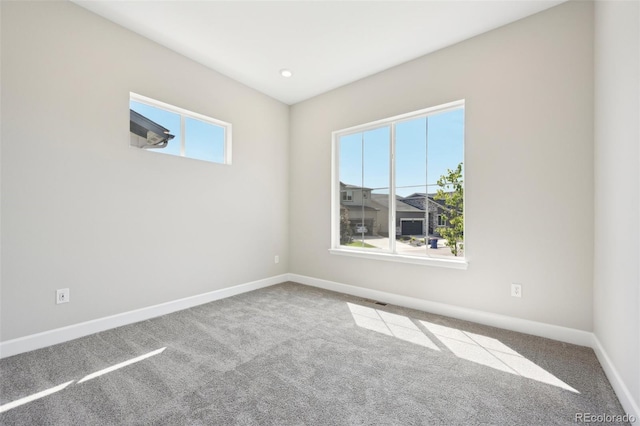 unfurnished room featuring carpet floors and plenty of natural light