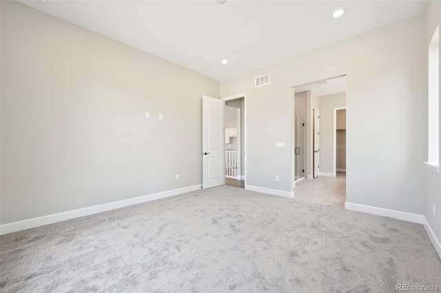 unfurnished bedroom with light colored carpet