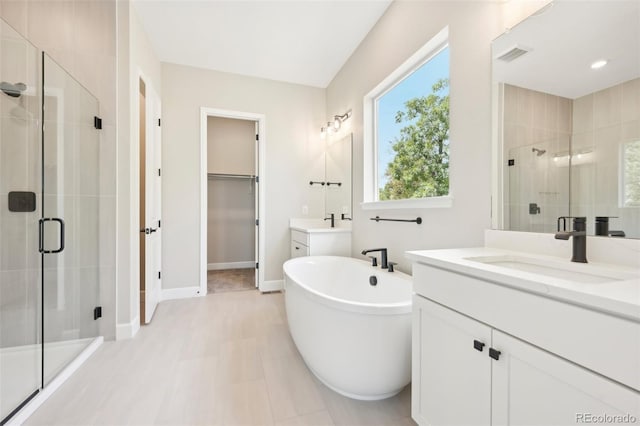 bathroom with independent shower and bath and vanity