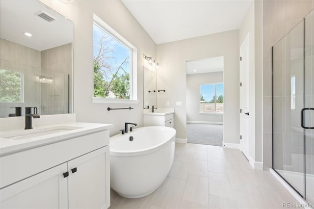 bathroom with vanity, tile patterned floors, plus walk in shower, and a healthy amount of sunlight