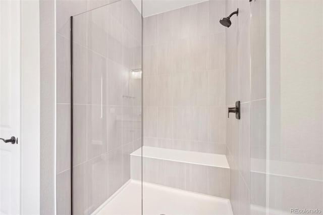 bathroom with a tile shower