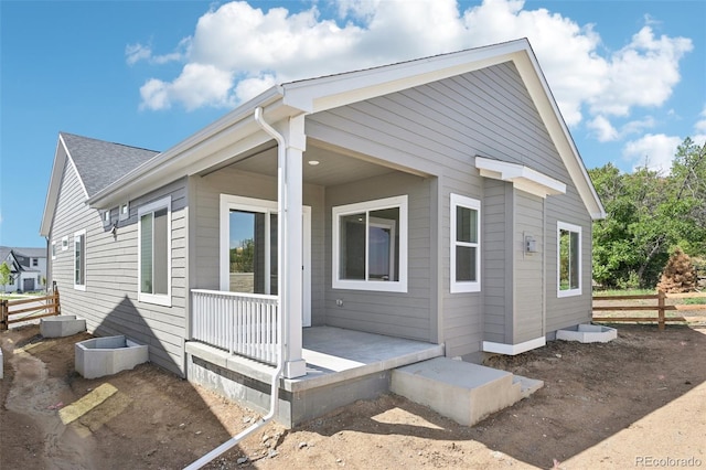 back of property with a porch