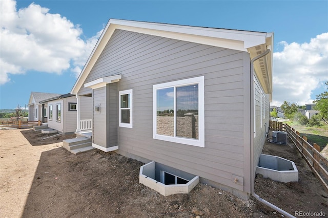 view of side of home featuring central AC unit