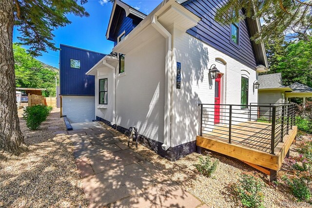 1029 9th St, Boulder, CO 80302 - view of property exterior with brick siding and a deck
