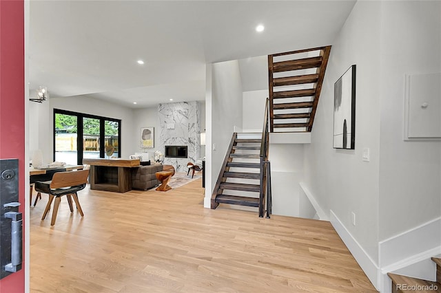 1029 9th St, Boulder, CO 80302 - living room featuring stairway, light wood-style flooring, a high end fireplace, and recessed lighting