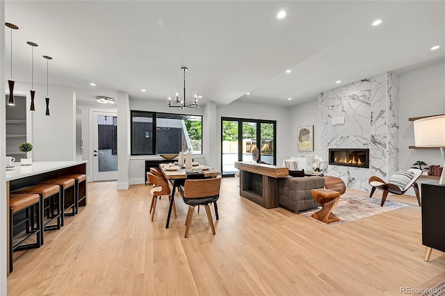 1029 9th St, Boulder, CO 80302 - living room with light wood-style flooring, recessed lighting, a fireplace, and a chandelier