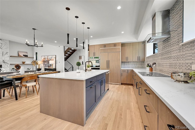 1029 9th St, Boulder, CO 80302 - kitchen featuring wall chimney exhaust hood, light wood finished floors, decorative backsplash, stainless steel appliances, and recessed lighting