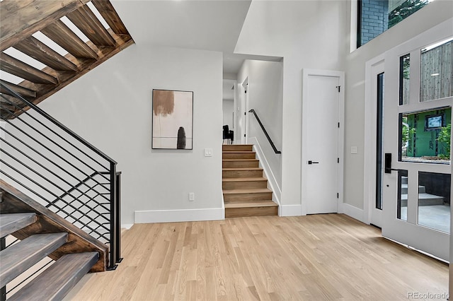 1029 9th St, Boulder, CO 80302 - entrance foyer with stairs, light wood finished floors, and a towering ceiling