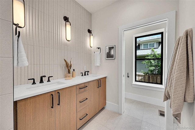 1029 9th St, Boulder, CO 80302 - full bath with tile patterned floors, double vanity, and decorative backsplash