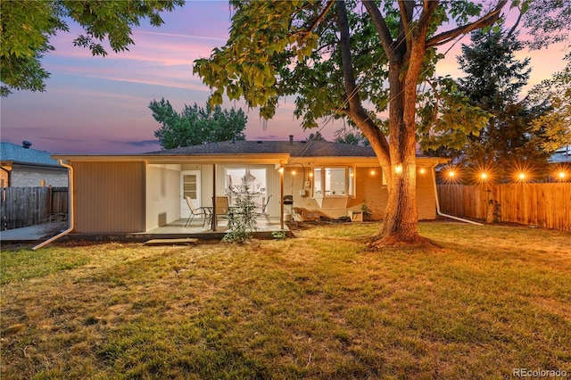 8060 Stuart Pl, Westminster, CO 80031 - back of property at dusk featuring a fenced backyard