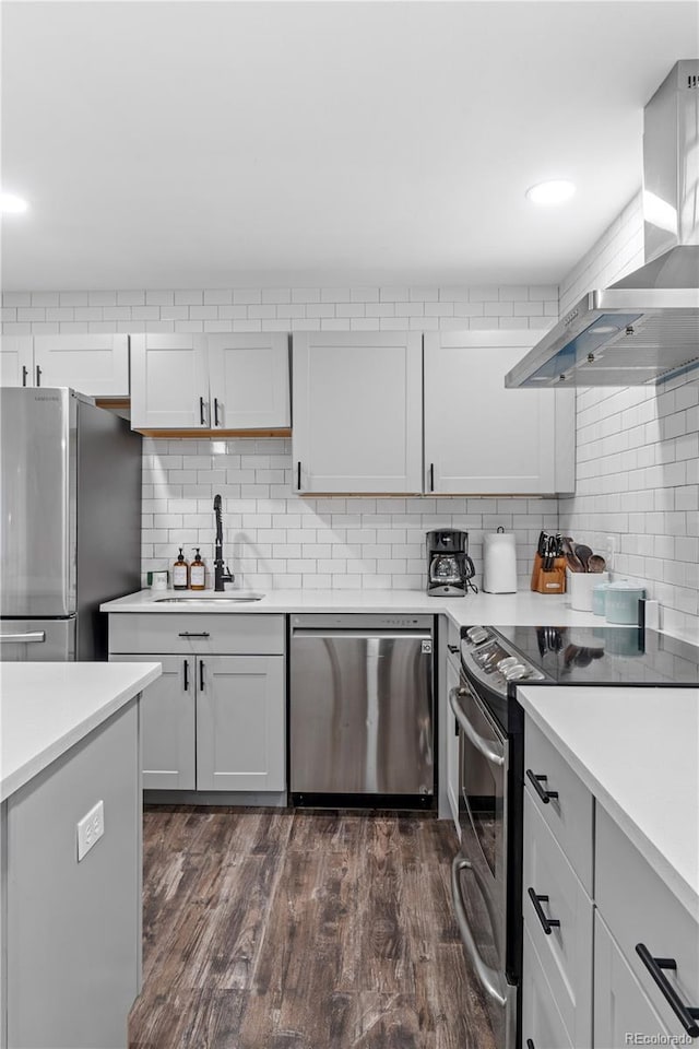 8060 Stuart Pl, Westminster, CO 80031 - kitchen with appliances with stainless steel finishes, wall chimney exhaust hood, light countertops, and decorative backsplash