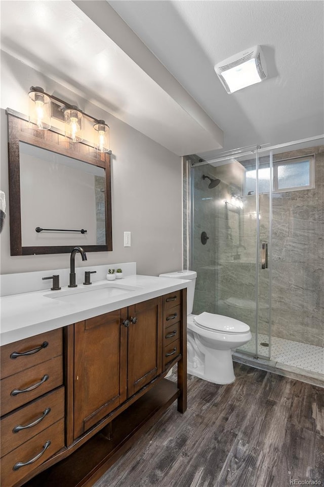 8060 Stuart Pl, Westminster, CO 80031 - full bath featuring vanity, wood finished floors, and a shower stall
