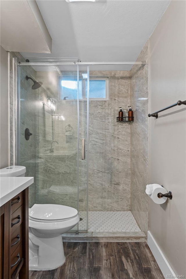 8060 Stuart Pl, Westminster, CO 80031 - bathroom featuring vanity, wood finished floors, and a stall shower