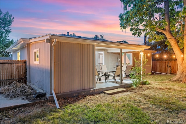 8060 Stuart Pl, Westminster, CO 80031 - back of house at dusk with a patio and a fenced backyard