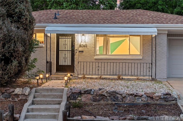 8060 Stuart Pl, Westminster, CO 80031 - property entrance with brick siding and a shingled roof