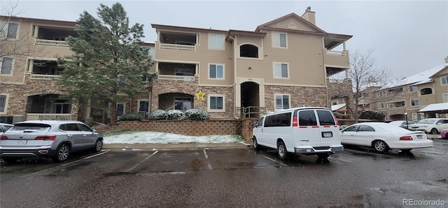 view of property with uncovered parking
