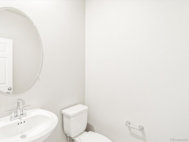 half bathroom with a sink and toilet