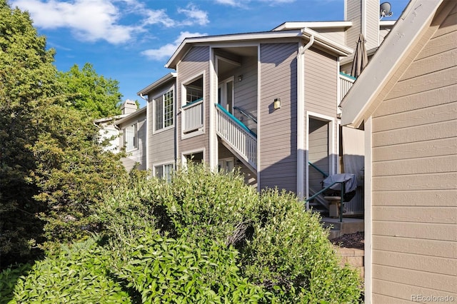 3857 Mossy Rock Dr Unit 201, Highlands Ranch, CO 80126 - view of side of home featuring a chimney