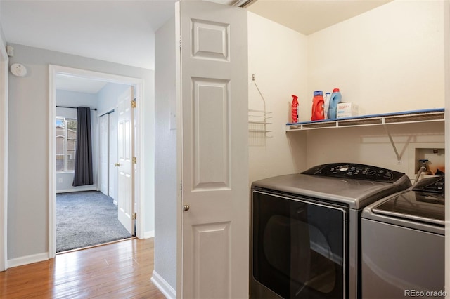 3857 Mossy Rock Dr Unit 201, Highlands Ranch, CO 80126 - laundry room featuring separate washer and dryer and light wood-type flooring