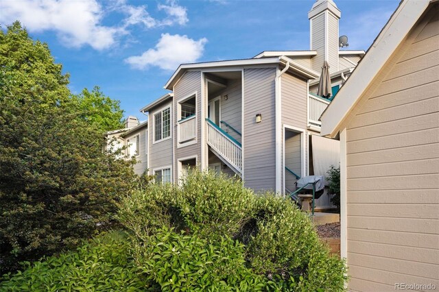 3857 Mossy Rock Dr Unit 201, Highlands Ranch, CO 80126 - view of side of property with a chimney