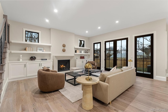 living room with a healthy amount of sunlight and light hardwood / wood-style flooring