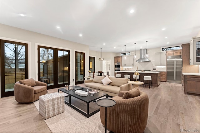 living room with french doors and light hardwood / wood-style flooring