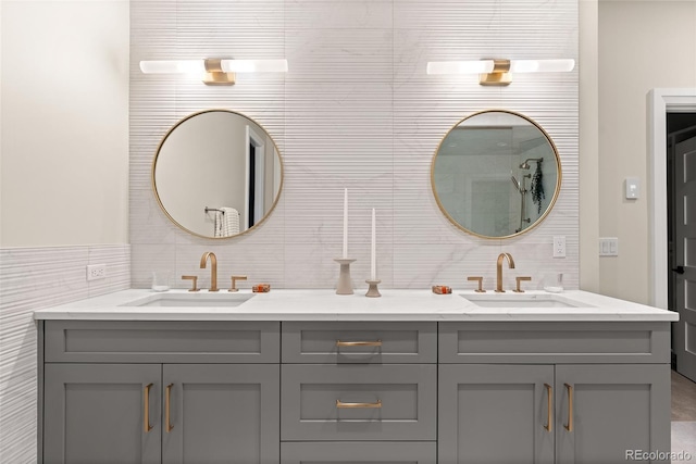 bathroom with vanity and tile walls