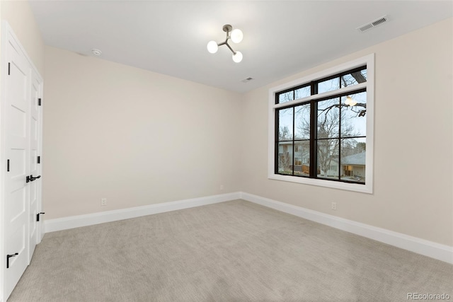 empty room featuring light colored carpet