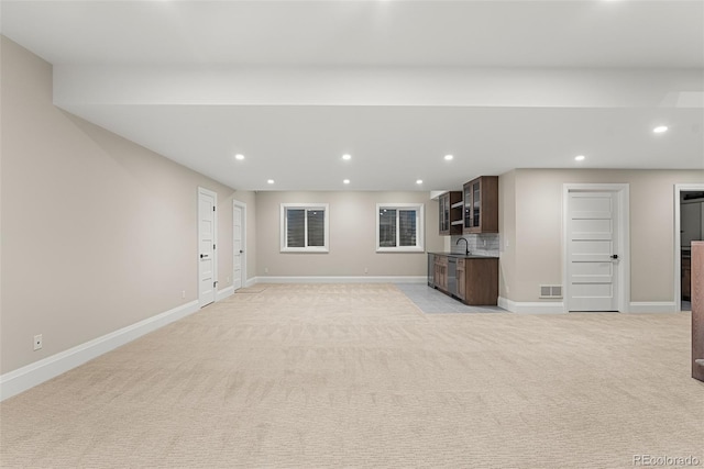 unfurnished living room featuring visible vents, recessed lighting, baseboards, and light carpet