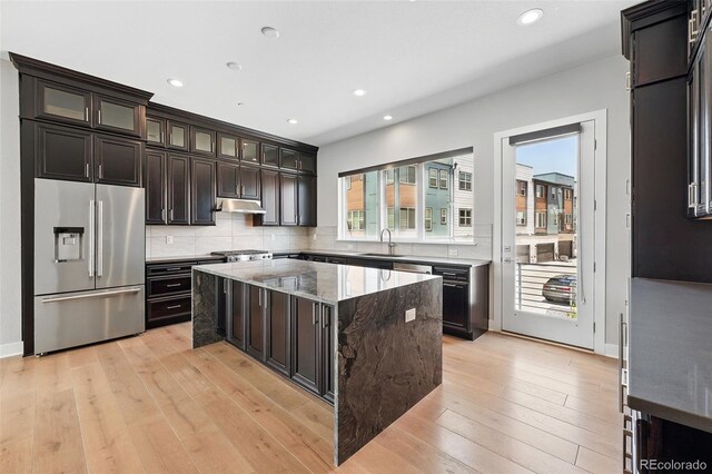815 Promenade Dr, Superior, CO 80027 - kitchen featuring high quality fridge, a sink, under cabinet range hood, a center island, and backsplash
