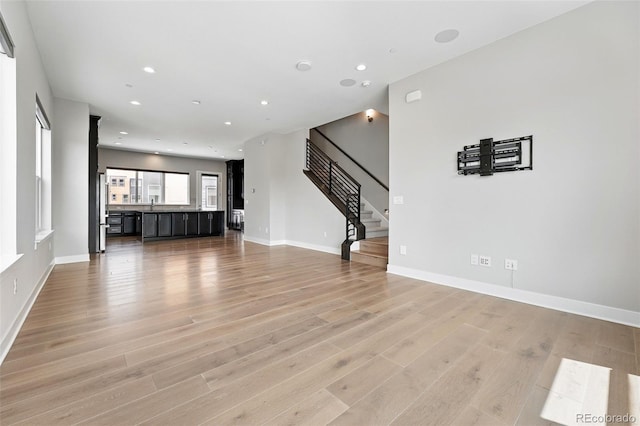 815 Promenade Dr, Superior, CO 80027 - unfurnished living room with light wood-style floors, stairway, recessed lighting, and baseboards