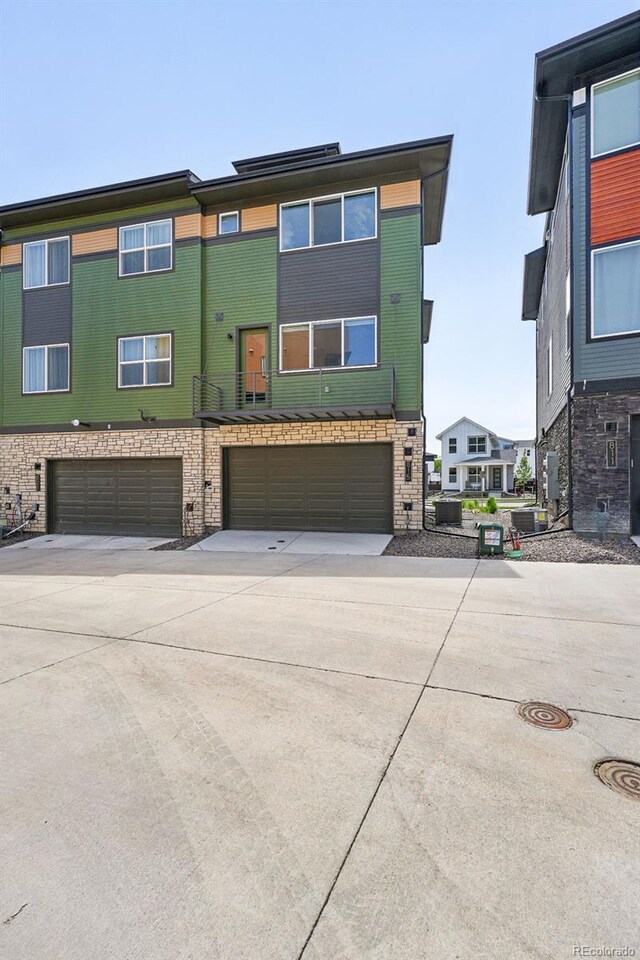815 Promenade Dr, Superior, CO 80027 - view of front of property featuring a garage, concrete driveway, and brick siding