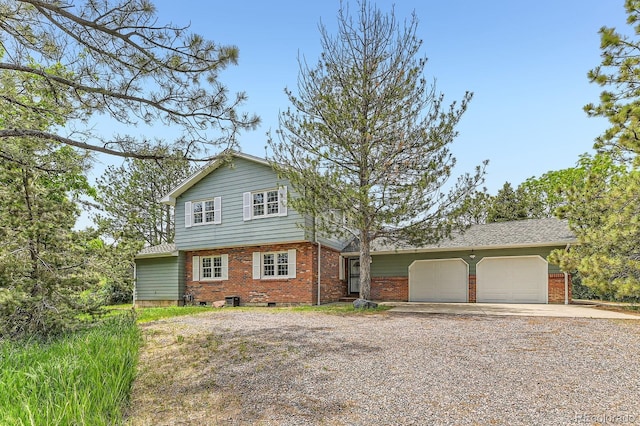 6351 S Andes Pl, Centennial, CO 80016 - view of front of house with brick siding, gravel driveway, and a garage