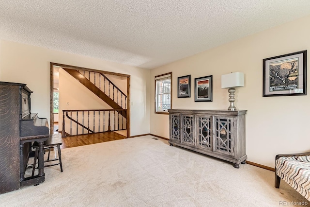 6351 S Andes Pl, Centennial, CO 80016 - living area featuring carpet, baseboards, stairs, and a textured ceiling