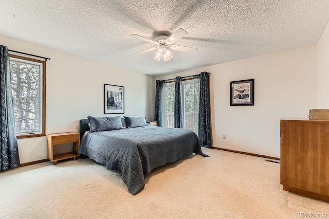 6351 S Andes Pl, Centennial, CO 80016 - bedroom with light carpet, baseboards, access to exterior, a ceiling fan, and a textured ceiling