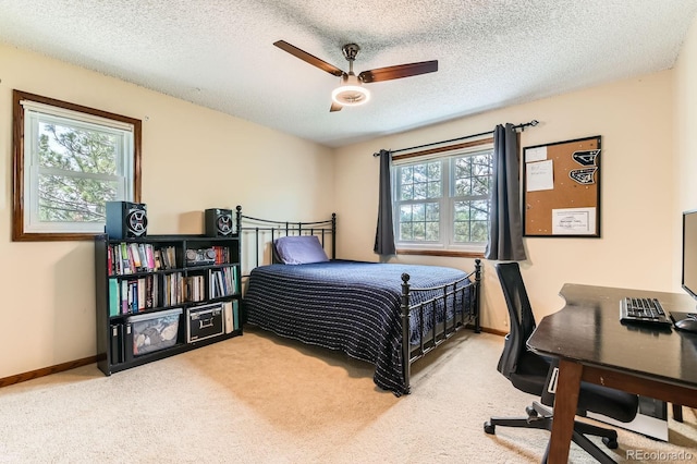 6351 S Andes Pl, Centennial, CO 80016 - carpeted bedroom featuring multiple windows, an office area, a textured ceiling, baseboards, and a ceiling fan