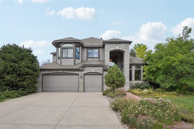 2841 Wyecliff Way, Highlands Ranch, CO 80126 - view of front of home featuring an attached garage, concrete driveway, a shingled roof, and stone siding