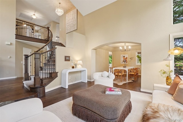 2841 Wyecliff Way, Highlands Ranch, CO 80126 - living area featuring a high ceiling, arched walkways, wood finished floors, a chandelier, and stairway