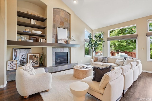 2841 Wyecliff Way, Highlands Ranch, CO 80126 - living room featuring wood finished floors, high vaulted ceiling, a tile fireplace, and built in features