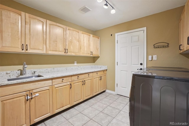 2841 Wyecliff Way, Highlands Ranch, CO 80126 - laundry area featuring cabinet space, light tile patterned floors, washing machine and dryer, and track lighting
