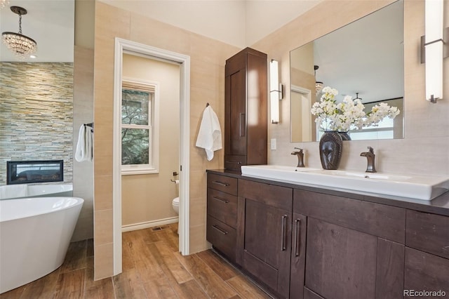 2841 Wyecliff Way, Highlands Ranch, CO 80126 - full bath featuring wood finished floors, a freestanding tub, and double vanity