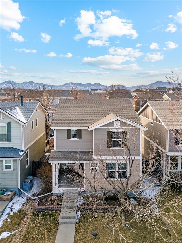 view of front of house with central AC unit and a mountain view