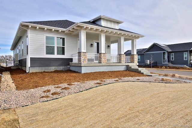 view of front of house featuring a porch and a shingled roof