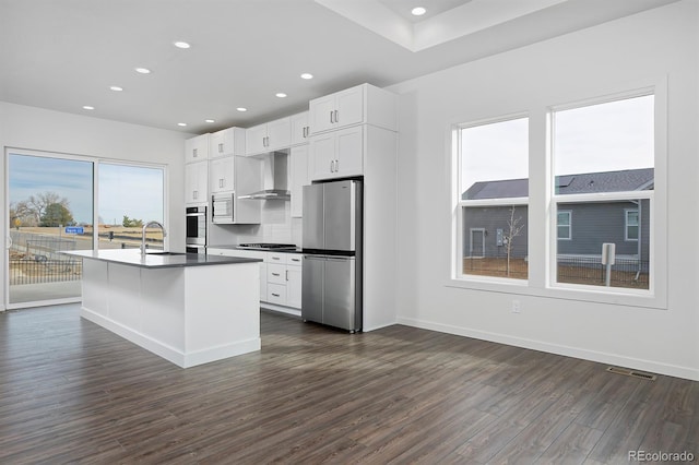 kitchen featuring visible vents, a sink, extractor fan, stainless steel appliances, and dark wood-style flooring