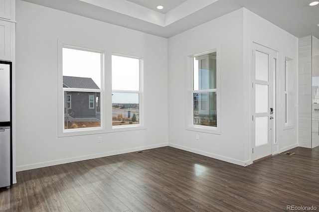 unfurnished room with recessed lighting, visible vents, baseboards, and dark wood-type flooring